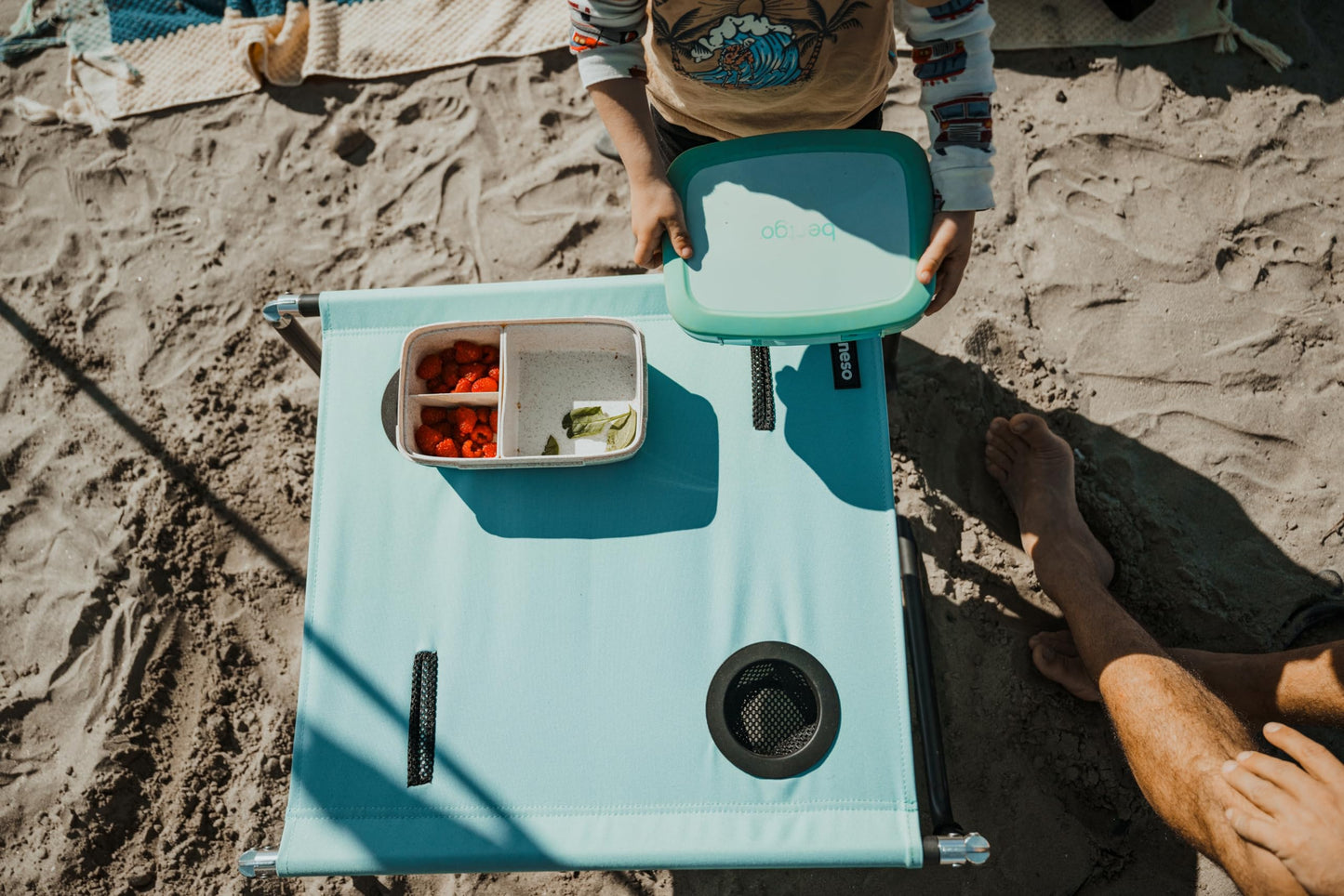 Neso Beach Table - Lightweight, Portable and Foldable Table for Beach, Camping and Outdoor Adventures - Stable Surface - with Cup Holder for Drinks and Phone Pockets - Seafoam