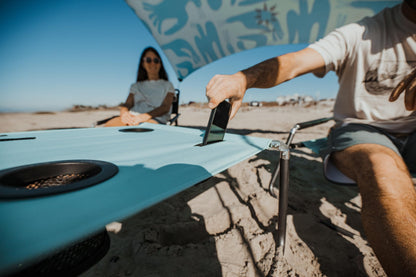 Neso Beach Table - Lightweight, Portable and Foldable Table for Beach, Camping and Outdoor Adventures - Stable Surface - with Cup Holder for Drinks and Phone Pockets - Seafoam